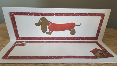Cute Sausage Dog in Red with Kennel Dl Insert by Hayley Griffiths
