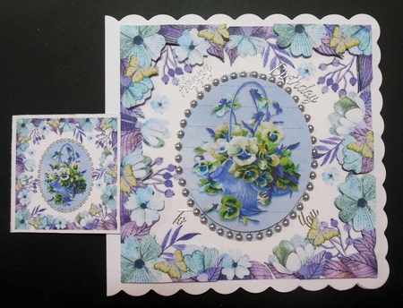 pretty lilac/blues pansies in a basket in floral frame with butterflies 8x8 by Hazel Sumner