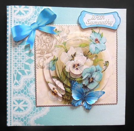 Pretty blue and white pansies with bow circle pyramids by Hazel Sumner