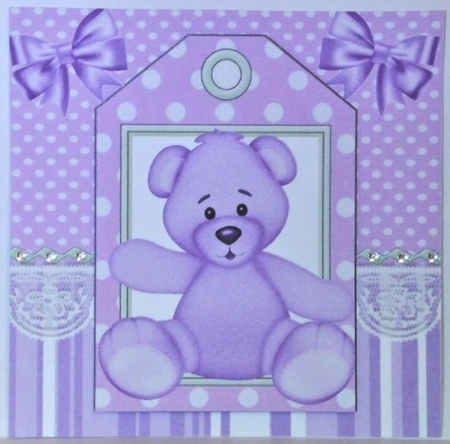 Cute purple teddy on a tag topper with bows by Hazel Underwood