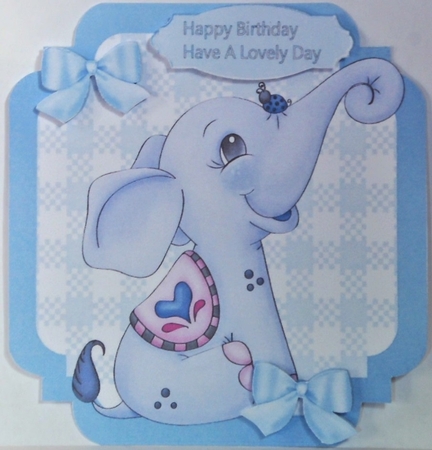 lovely little blue elephant with bows  on check 7x7 topper by Hazel Underwood