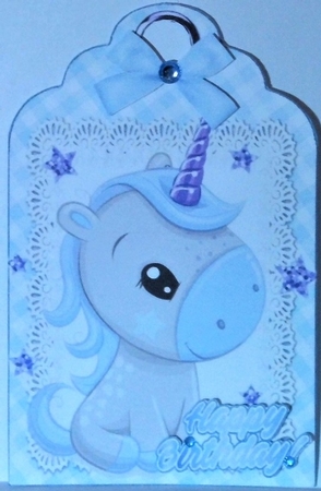 Cute little unicorn on lace tag/topper with blue bow by Hazel Underwood