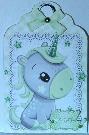 Cute little unicorn on lace tag/topper with green bow by Hazel Underwood