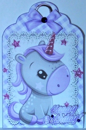 Cute little unicorn on lace tag/topper with purple bow by Hazel Underwood