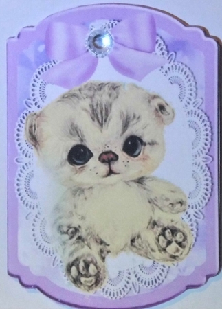 Cute littler kitten with lilac bow on lace bracket card by Hazel Underwood