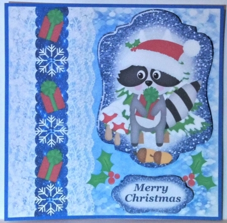 Blue Christmas present raccoon card front by Hazel Underwood