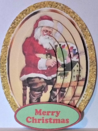Santa in his workshop with holly in gold glitter oval pyramids by Hazel Underwood