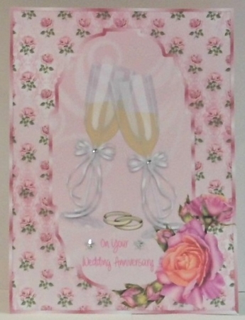 Wedding Anniversary card front with pink roses and champagne glasses by Hazel Underwood