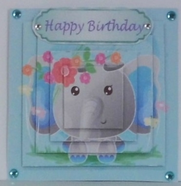 Cute painted  elephant with flowers and turq bow pyramids  by Hazel Underwood