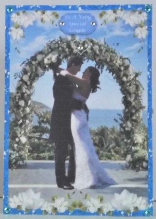 Bride & Groom Under green archway by Hazel Underwood