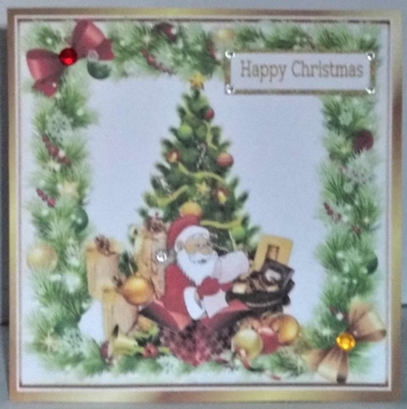 santa with his christmas list and presents with tree in holly frame 8x8 by Hazel Underwood