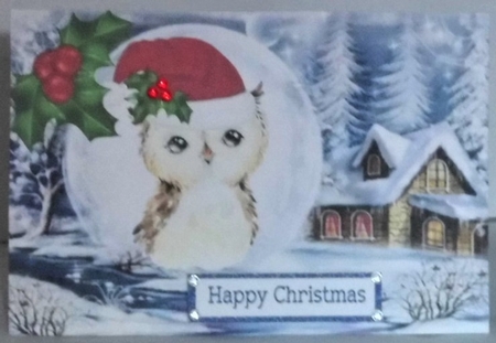 Lovely snow scene with owl in santa hat in snowball with holly A5 by Hazel Underwood
