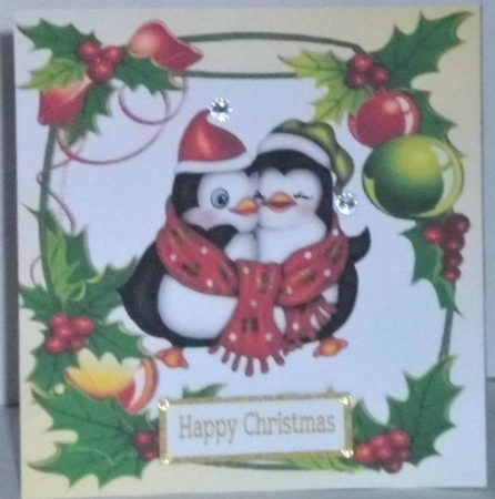 Lovely cuddle penguins in holly and berry frame 8x8 by Hazel Underwood