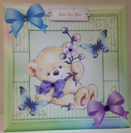 Cute teddy holding flowers with butterflies in rainbow frame 8x8 with pyramids by Hazel Underwood