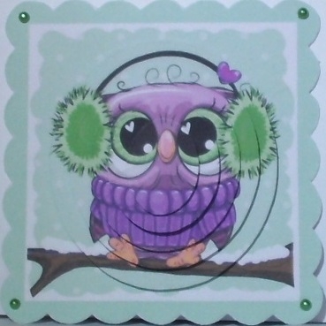 Cute owl on a branch with snow, oval pyramids (green) by Hazel Underwood