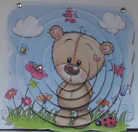 Cute teddy in flower garden oval pyramids by Hazel Underwood
