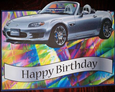 Silver Mazda Over the Edge by Helen Gomm