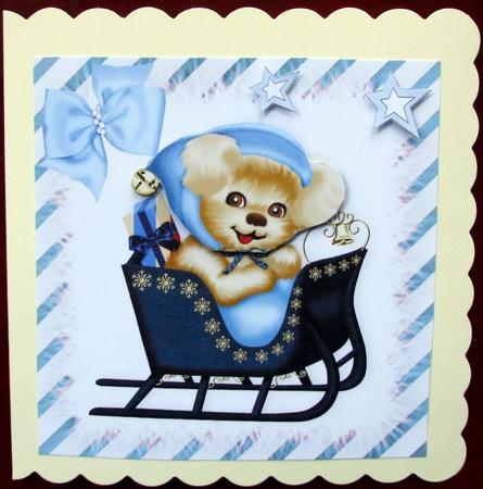 Cute Puppy in Blue in a Sleigh with Blue Bow by Hilary Shemmans