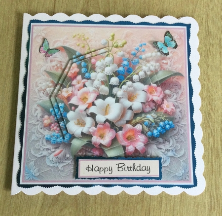 lily of the valley on lace with pyramid toppers  by Honorscard Appleby