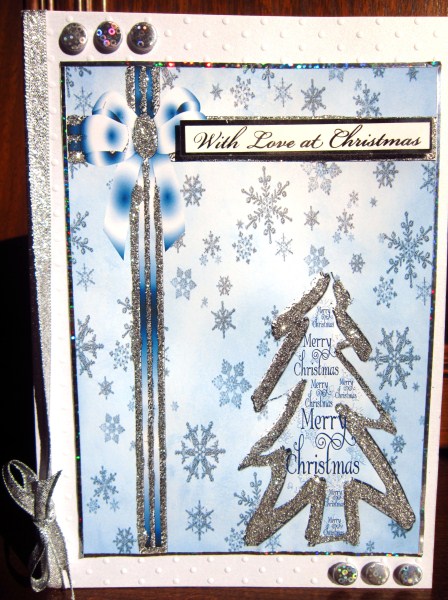 Silver Christmas Tree on Snowflakes Background by Janette Ellison
