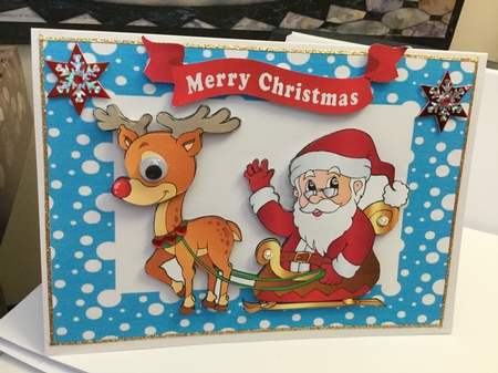 Santa with rudolph and his sleigh in blue snow frame by Jennie Settle