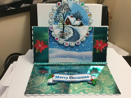 Lovely snow scene with cottage, and bow over the edge by Jennie Settle