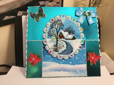 Lovely snow scene with cottage, and bow over the edge by Jennie Settle