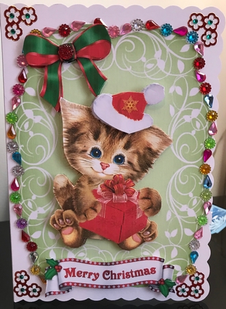Cute kitten in santa hat on leaf topper with red bow by Jennie Settle