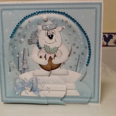 Christmas Snowglobe Ben Polar Bear has a Christmas Pudding Shell Edged Corner Stacker by Jennifer Purdon