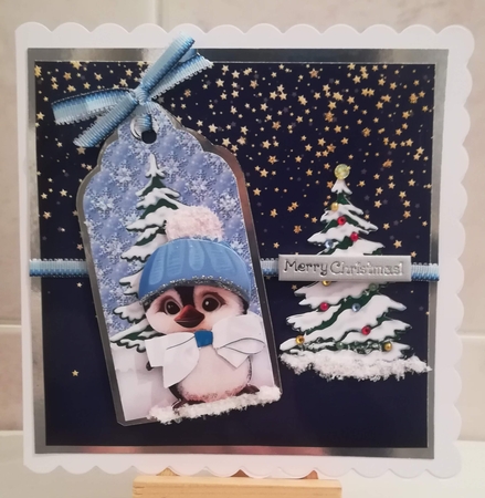 Cute little penguin in blue in snow scene tag with bow by Jennifer Selbie