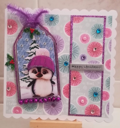 Cute little penguin in purple in snow scene tag with bow by Jennifer Selbie