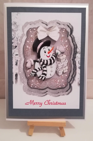 Lovely snowman with gifts on a scroll silver mat with bow by Jennifer Selbie