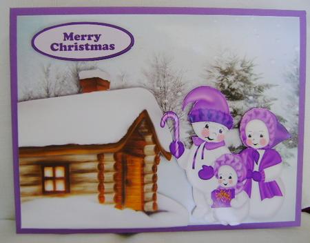 Snowman Family with Cottage in the Snow by Jennifer Archer