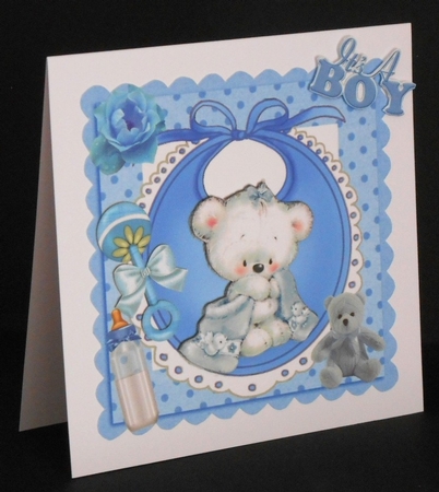 Cuddly teddy with his blanket, bottle on bib, in frame 8x8 by Joan Prince