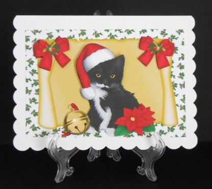 Little Black Kitten on a Scroll in Santa Hat by Joan Prince