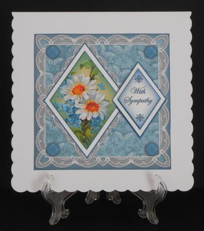 Teal Daisies with Sympathy 7in Double Diamond Topper by Joan Prince