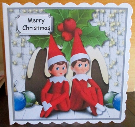 Elf on a shelf with Christmas Pudding by Johanna Lambert