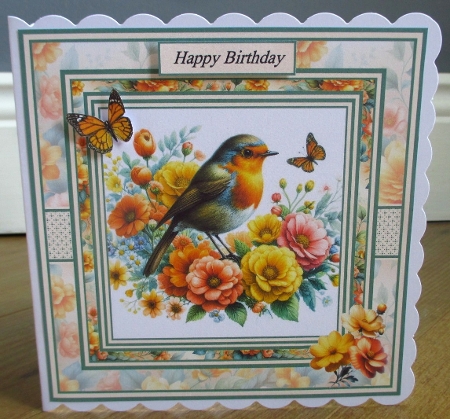 Minikit Robin perched on Flowers by Johanna Lambert