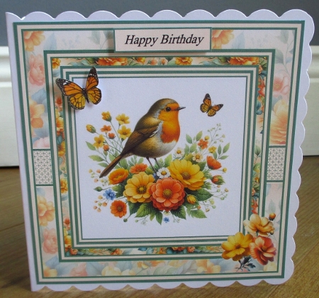 Minikit Robin perched on Flowers by Johanna Lambert