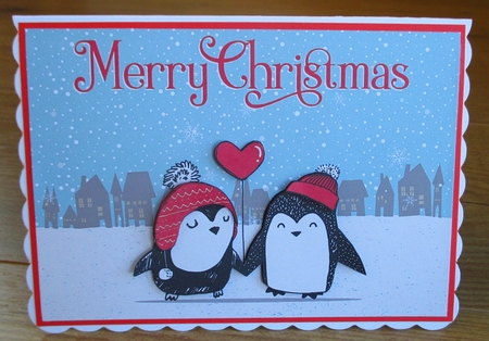 Couple Penguins Holding a Heart Balloon on a Snowy Christmas by Johanna Lambert