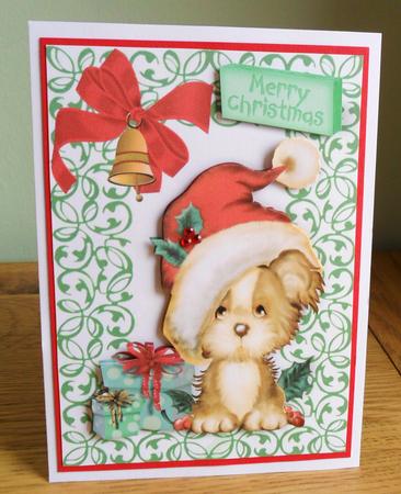 Puppy in Santa Hat with Presents by Johanna Lambert