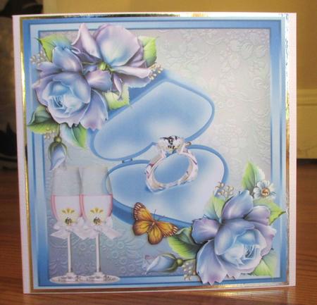 Beautiful Dusty Blue Roses with Engagement Ring by Johanna Lambert