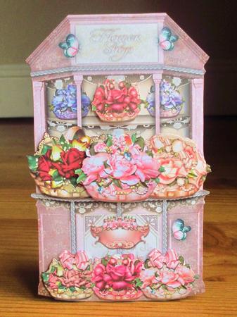 Beautiful White Flower Shop with Baskets Full of Roses by Johanna Lambert