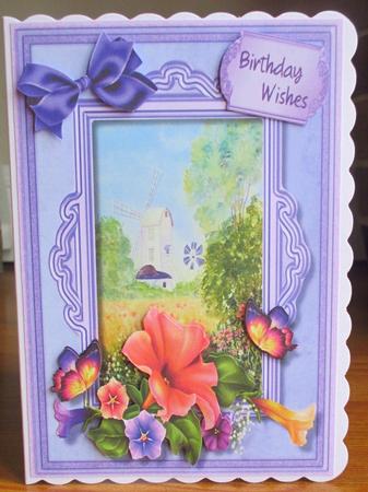 Beautiful Windmill, with Petunias and Butterrly's  by Johanna Lambert