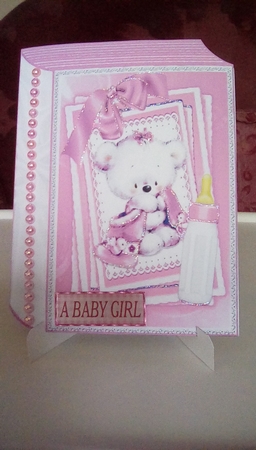 Cute little white bear with pink bow and  bottle on stacker and lace folded book by Joyce Edwards