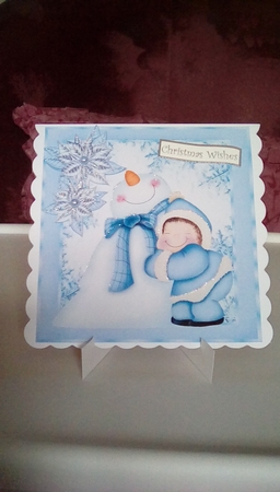 Cute Snowman having a cuddle in blue snow flake frame 8x8 by Joyce Edwards