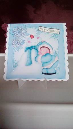 Cute Snowman having a cuddle in turq snow flake frame 8x8 by Joyce Edwards