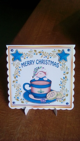 Santas little elf with blue stars & cookies in a teacup 8x8 by Joyce Edwards