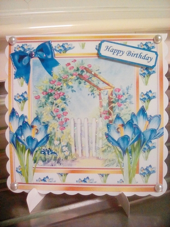 Pretty painted garden with gate and blue iris 8x8 by Joyce Edwards