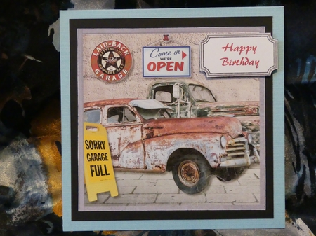 Rusty old cars in garage by Karen Glumm